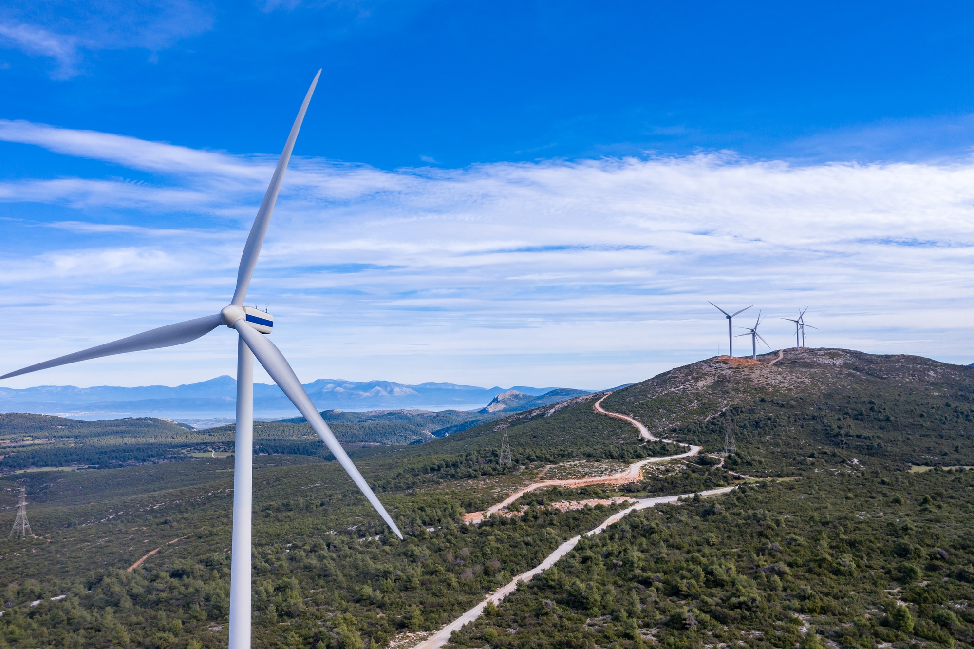 Wind turbines, renewable energy on a green hill. Wind farm